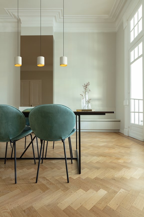 Cylinder-shaped pendant lighting above dining table