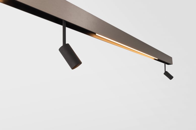 Adjustable spot lights on bronze linear lighting