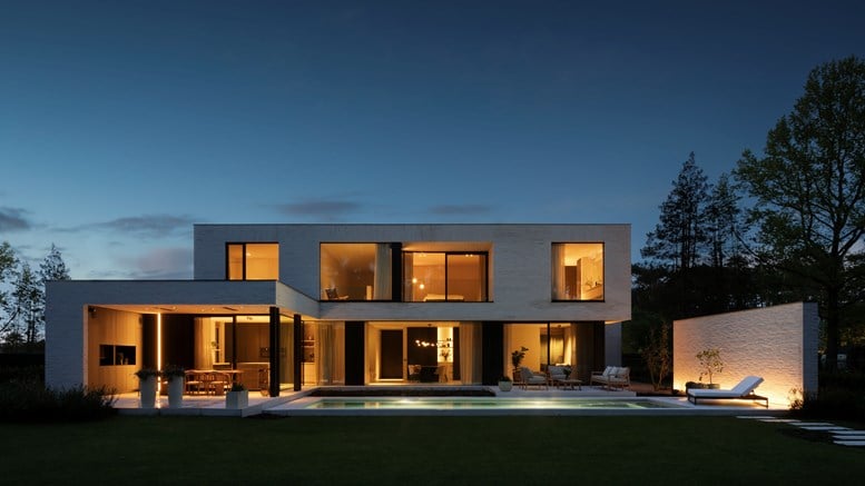 Big modern house with the lights on in the evening