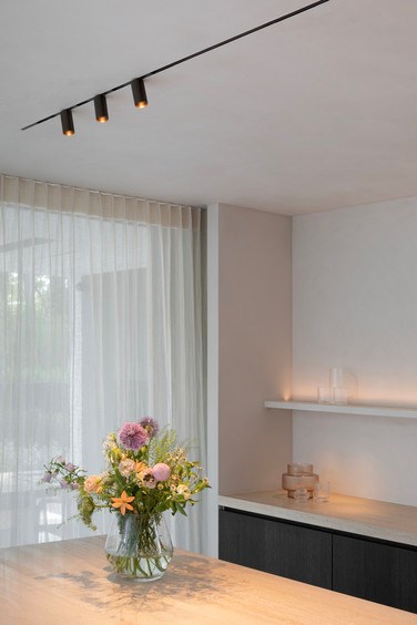 Modern kitchen counter with linear track lighting and downlighter spots