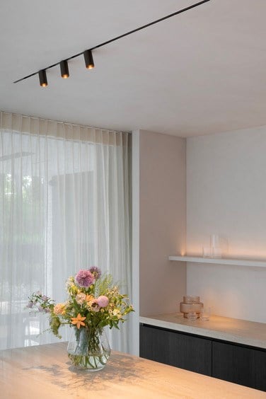 Modern kitchen counter with linear track lighting and downlighter spots