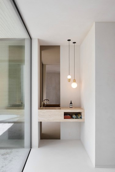 Modern bathroom with suspended champagne downlighters