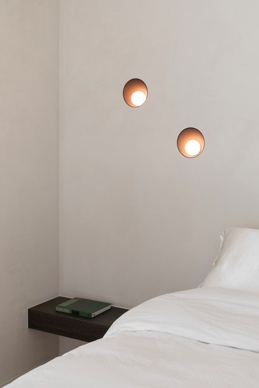 Modern bedroom with round recessed wall lighting